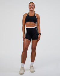 Woman wearing Distinction Sports Bra 2.0 - Black-White | Model:Sav | Size:S