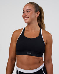 Woman wearing Distinction Sports Bra 2.0 - Black-White | Model:Sav | Size:S