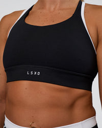 Woman wearing Distinction Sports Bra 2.0 - Black-White | Model:Sav | Size:S