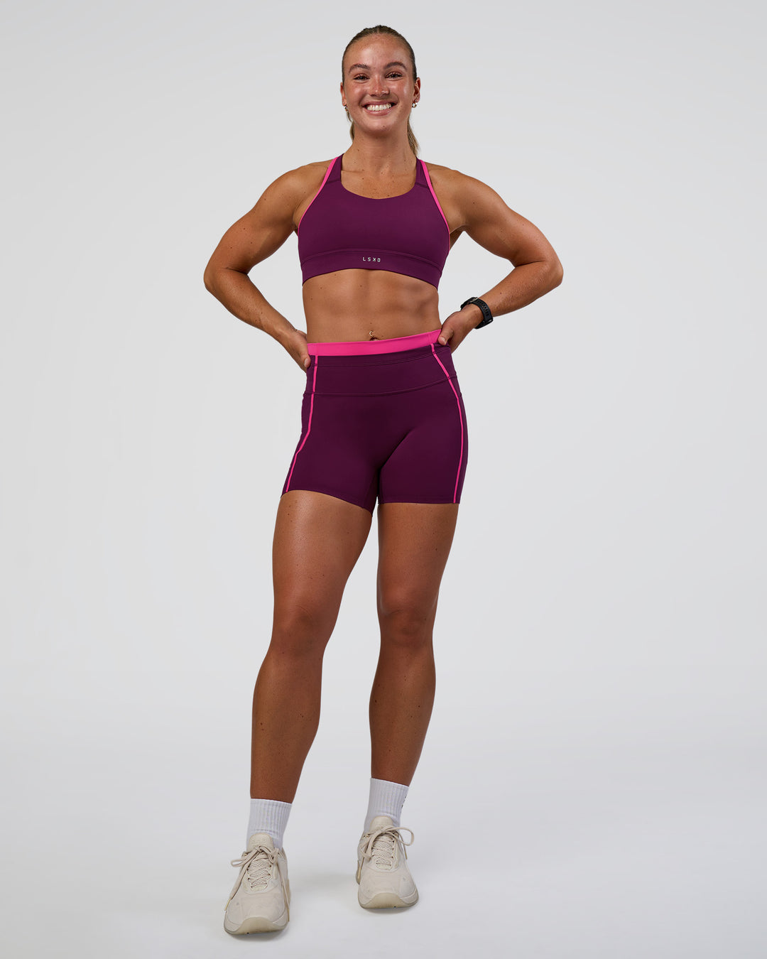 Woman wearing Distinction Sports Bra 2.0 - Plum Caspia-Ultra Pink | Model:Sav | Size:S