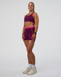 Woman wearing Distinction Sports Bra 2.0 - Plum Caspia-Ultra Pink | Model:Sav | Size:S