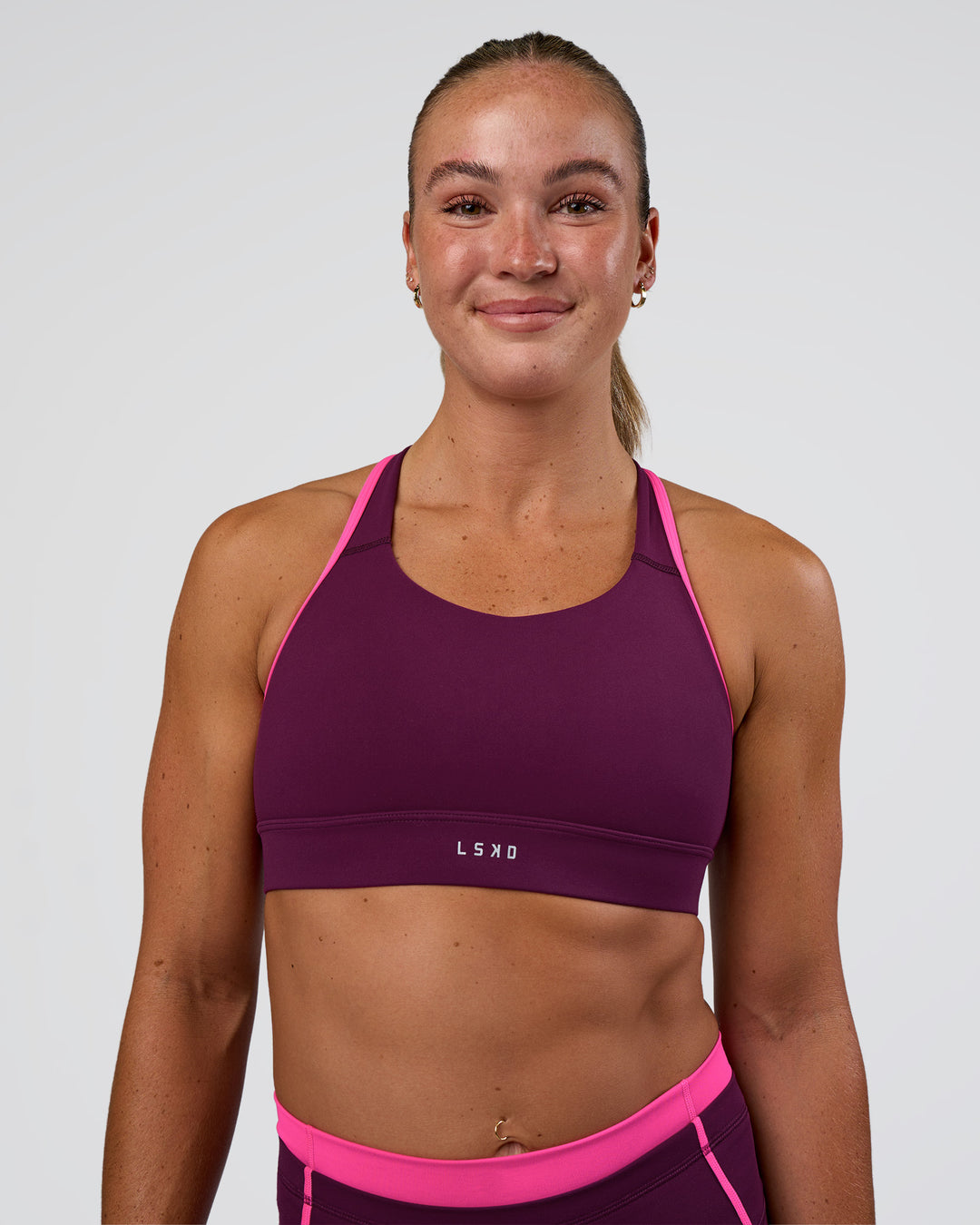 Woman wearing Distinction Sports Bra 2.0 - Plum Caspia-Ultra Pink | Model:Sav | Size:S