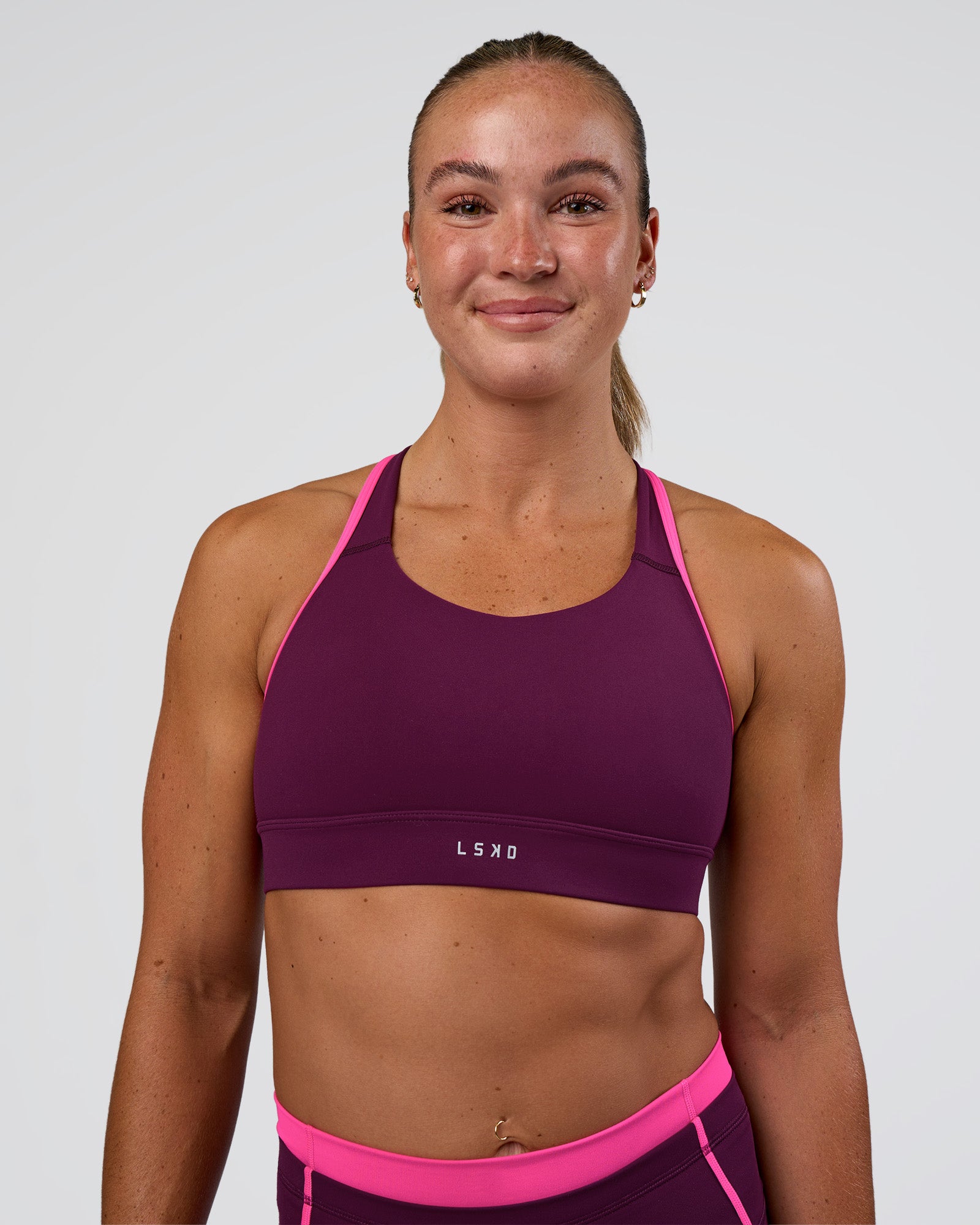 Woman wearing Distinction Sports Bra 2.0 - Plum Caspia-Ultra Pink | Model:Sav | Size:S