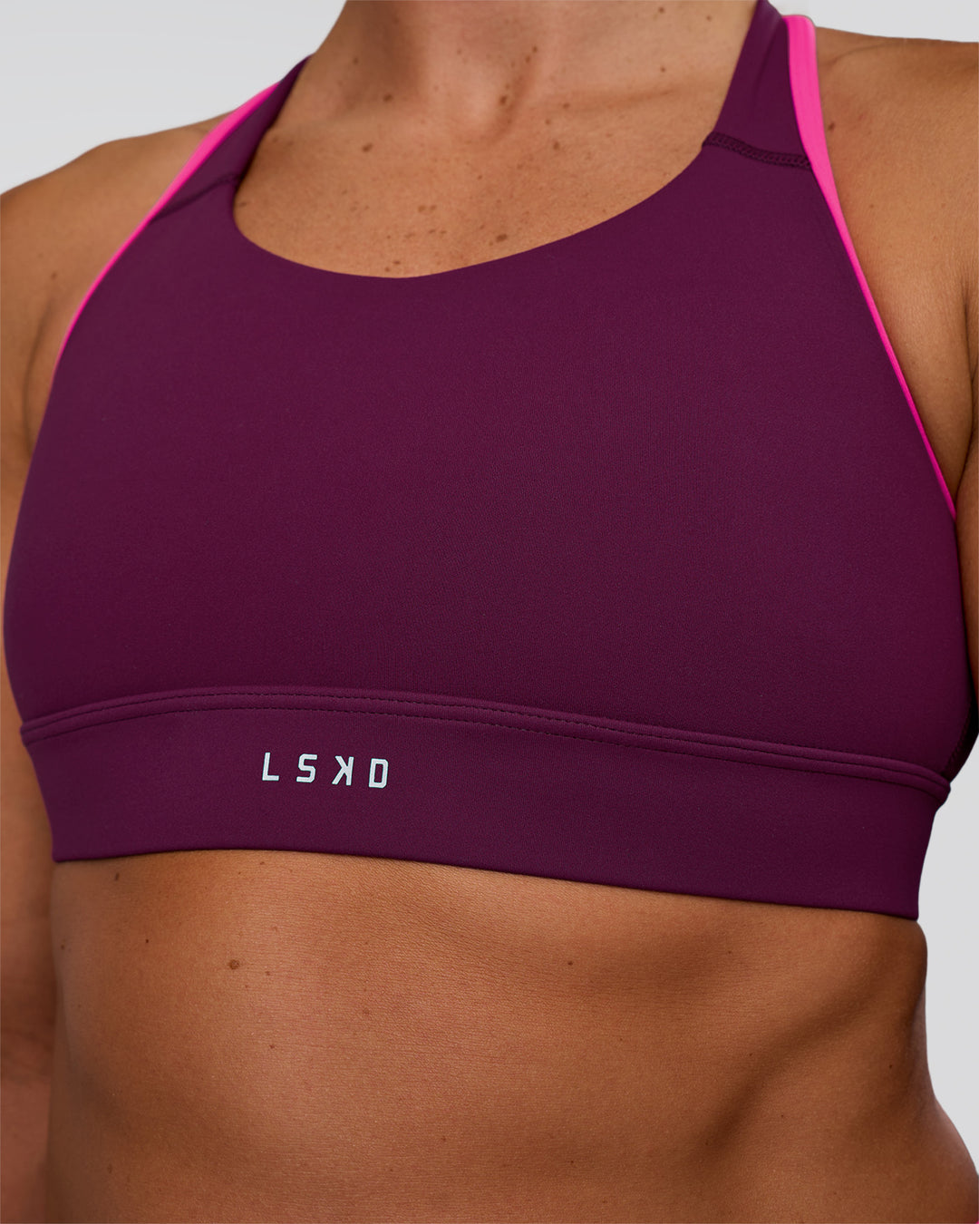 Woman wearing Distinction Sports Bra 2.0 - Plum Caspia-Ultra Pink | Model:Sav | Size:S