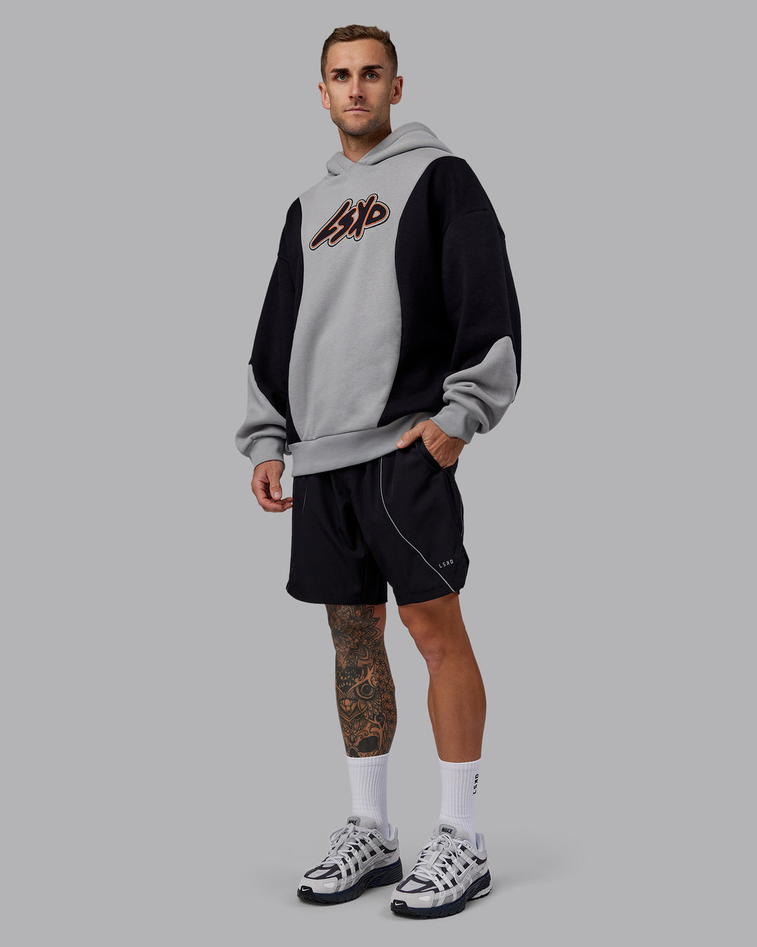Man wearing Downtown Oversized Panel Hoodie - Circular Grey - Black | Model:Tommy | Size:S