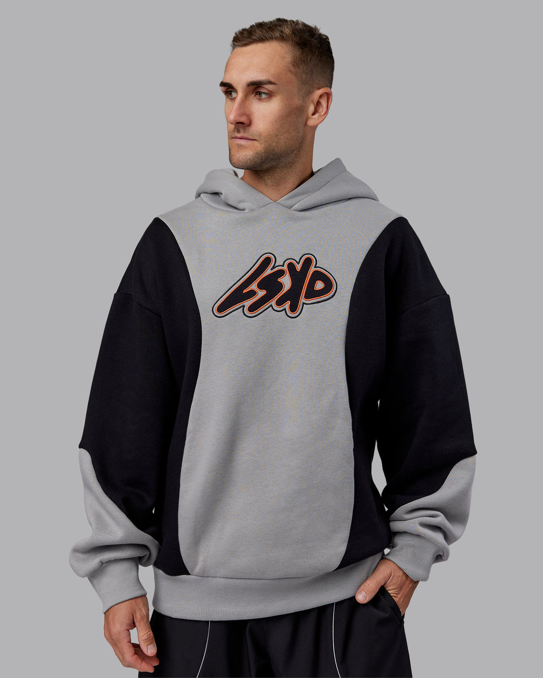 Man wearing Downtown Oversized Panel Hoodie - Circular Grey - Black | Model:Tommy | Size:S