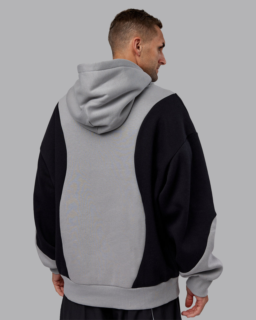 Man wearing Downtown Oversized Panel Hoodie - Circular Grey - Black | Model:Tommy | Size:S