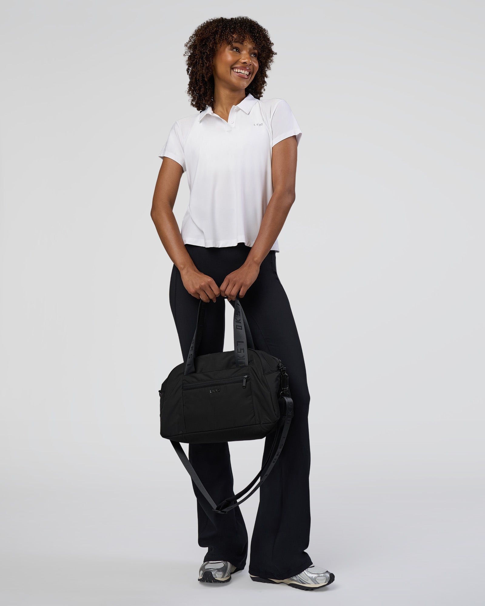 Woman wearing Drive Polo - White | Model:Tomi | Size:S