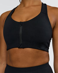 Woman wearing Elarra Zip Front Sports Bra - Black | Model:Rosie | Size:S