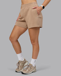 Woman wearing Elevate SoftTouch 4" Short - Light Taupe | Model:Halle | Size:S