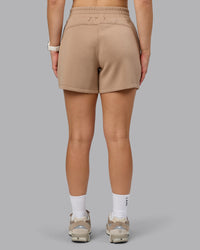 Woman wearing Elevate SoftTouch 4" Short - Light Taupe | Model:Halle | Size:S