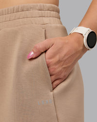 Woman wearing Elevate SoftTouch 4" Short - Light Taupe | Model:Halle | Size:S