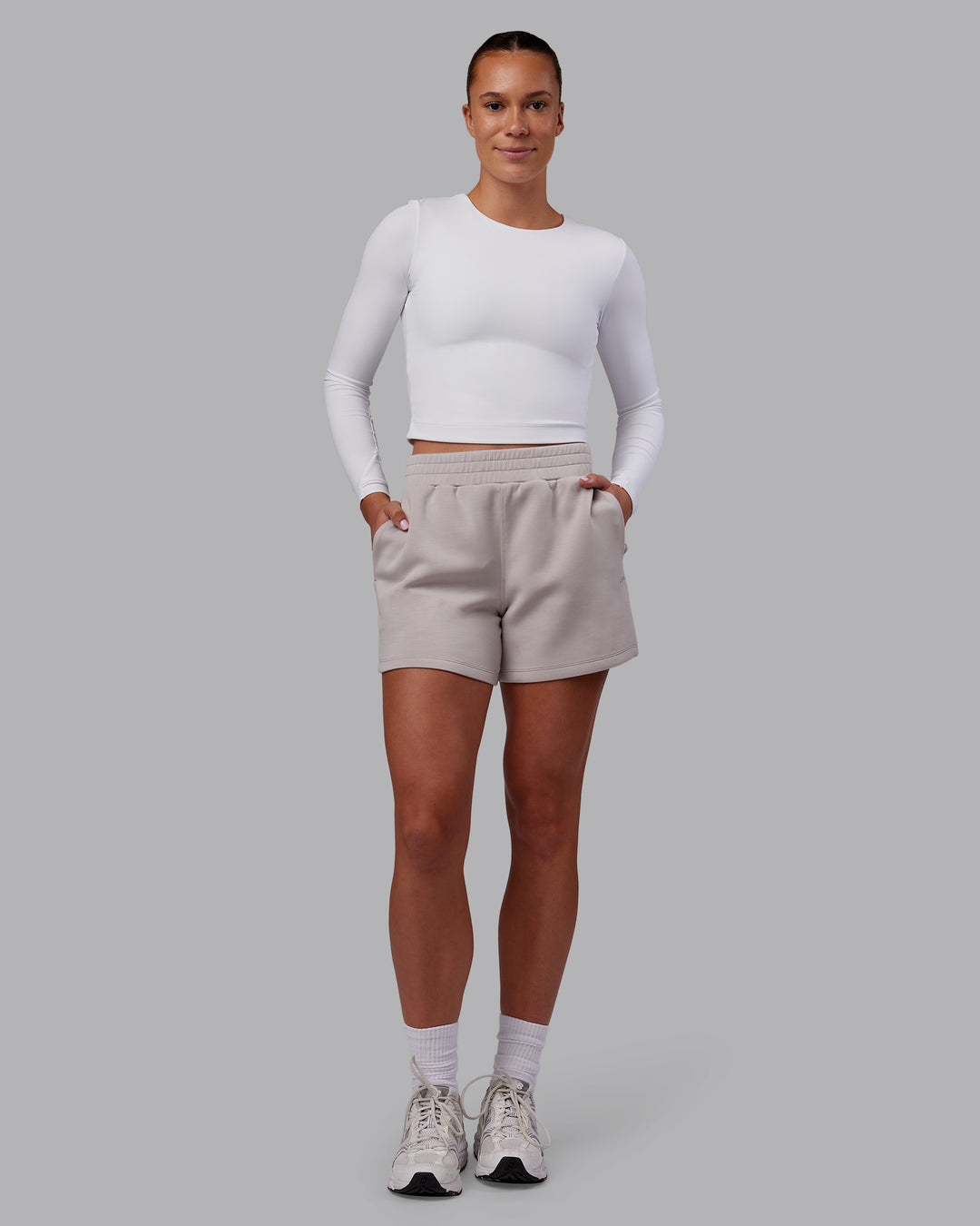 Woman wearing Elevate SoftTouch 4&quot; Short - Warm Grey | Model:Charlize | Size:S