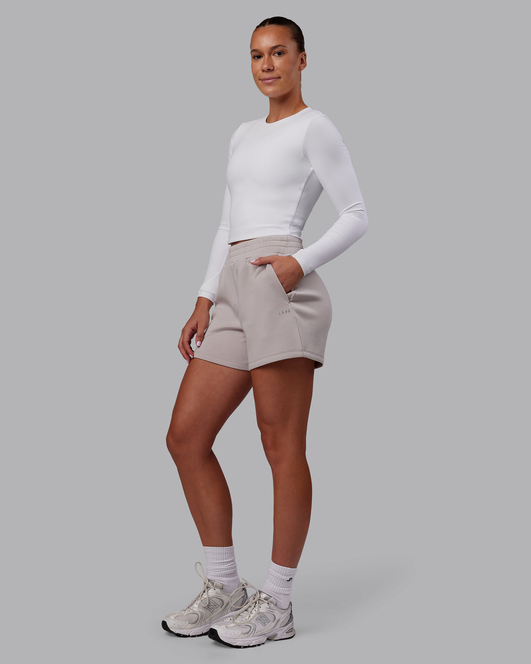Woman wearing Elevate SoftTouch 4&quot; Short - Warm Grey | Model:Charlize | Size:S