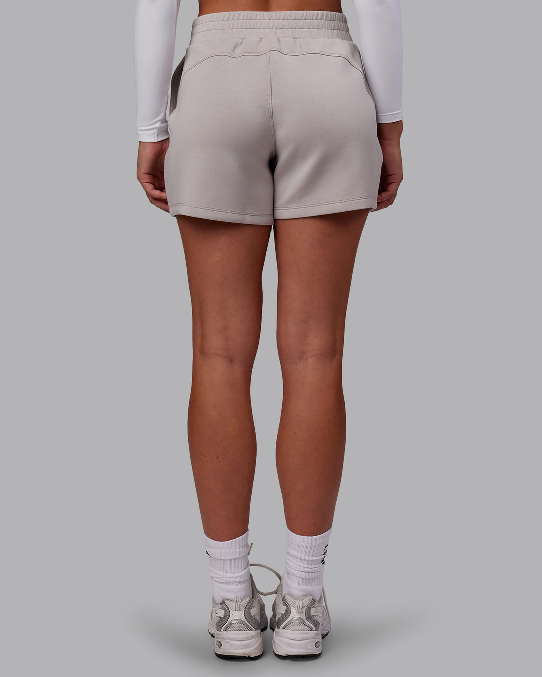 Woman wearing Elevate SoftTouch 4&quot; Short - Warm Grey | Model:Charlize | Size:S
