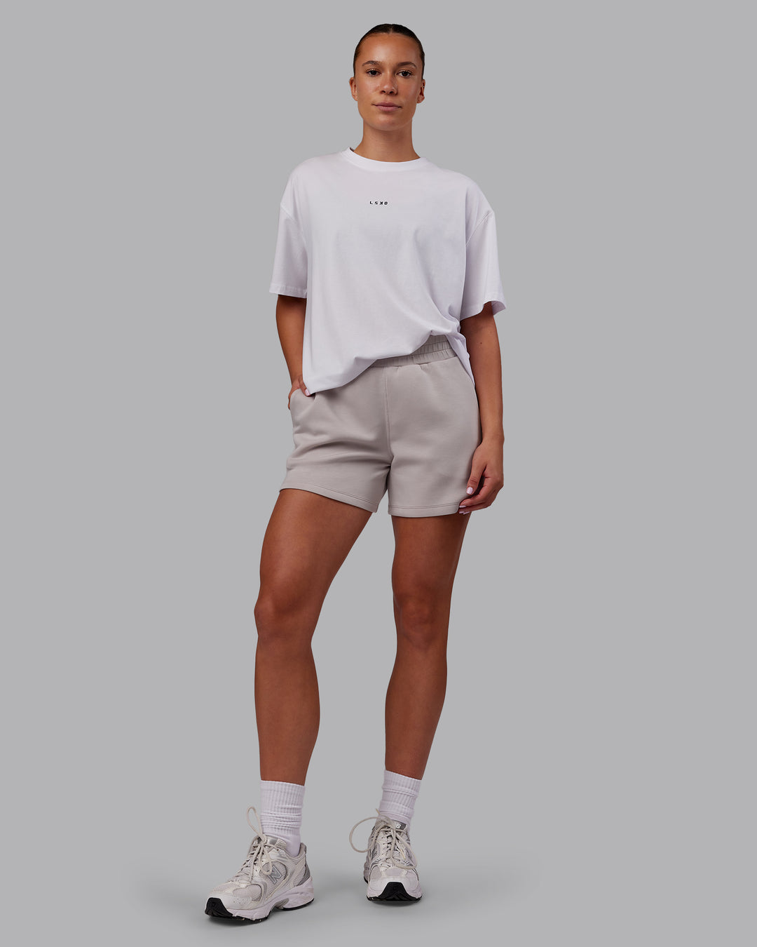 Woman wearing Elevate SoftTouch 4&quot; Short - Warm Grey | Model:Charlize | Size:S