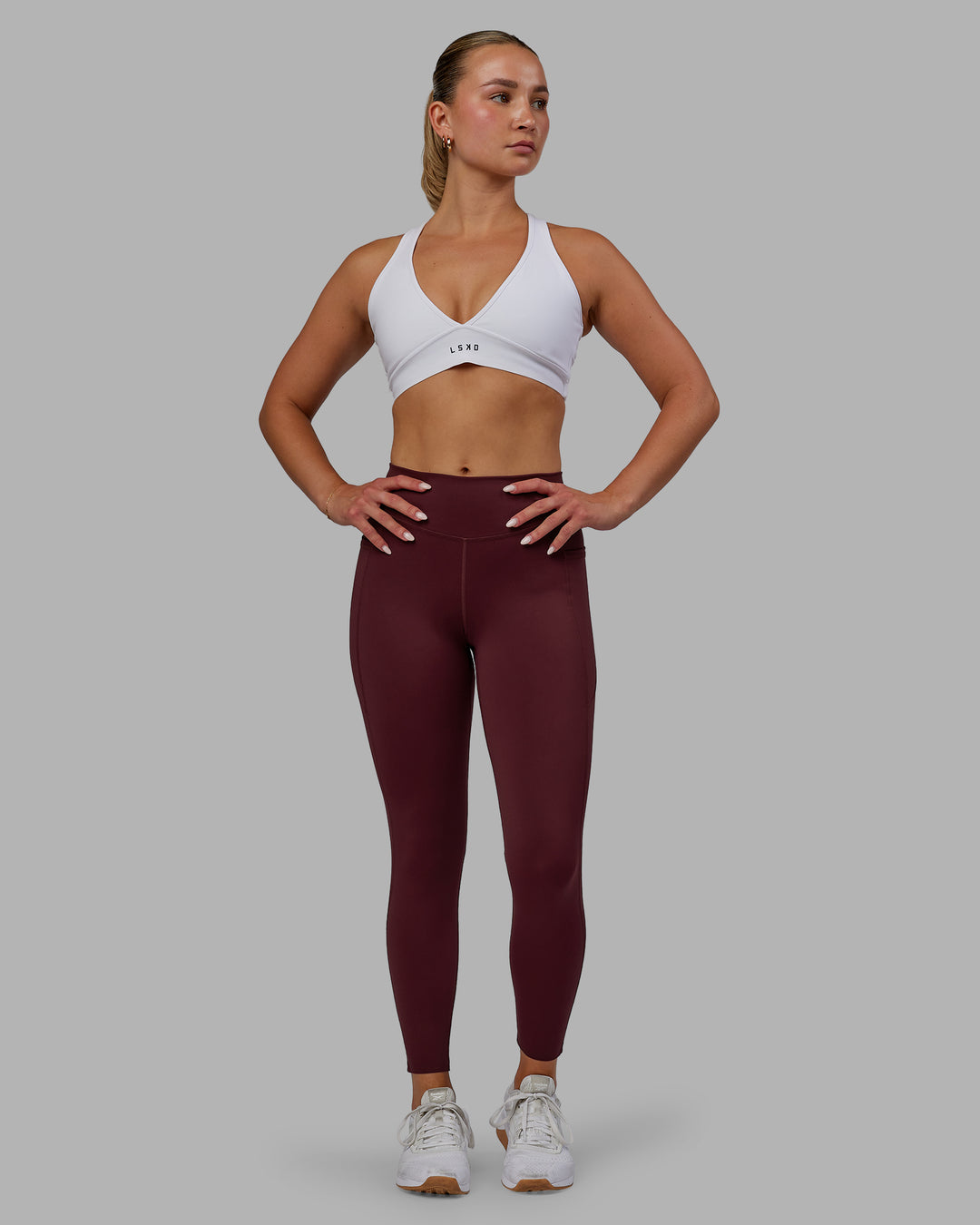 Woman wearing Elite High-Rise 7/8 Legging Pockets - Dark Cherry