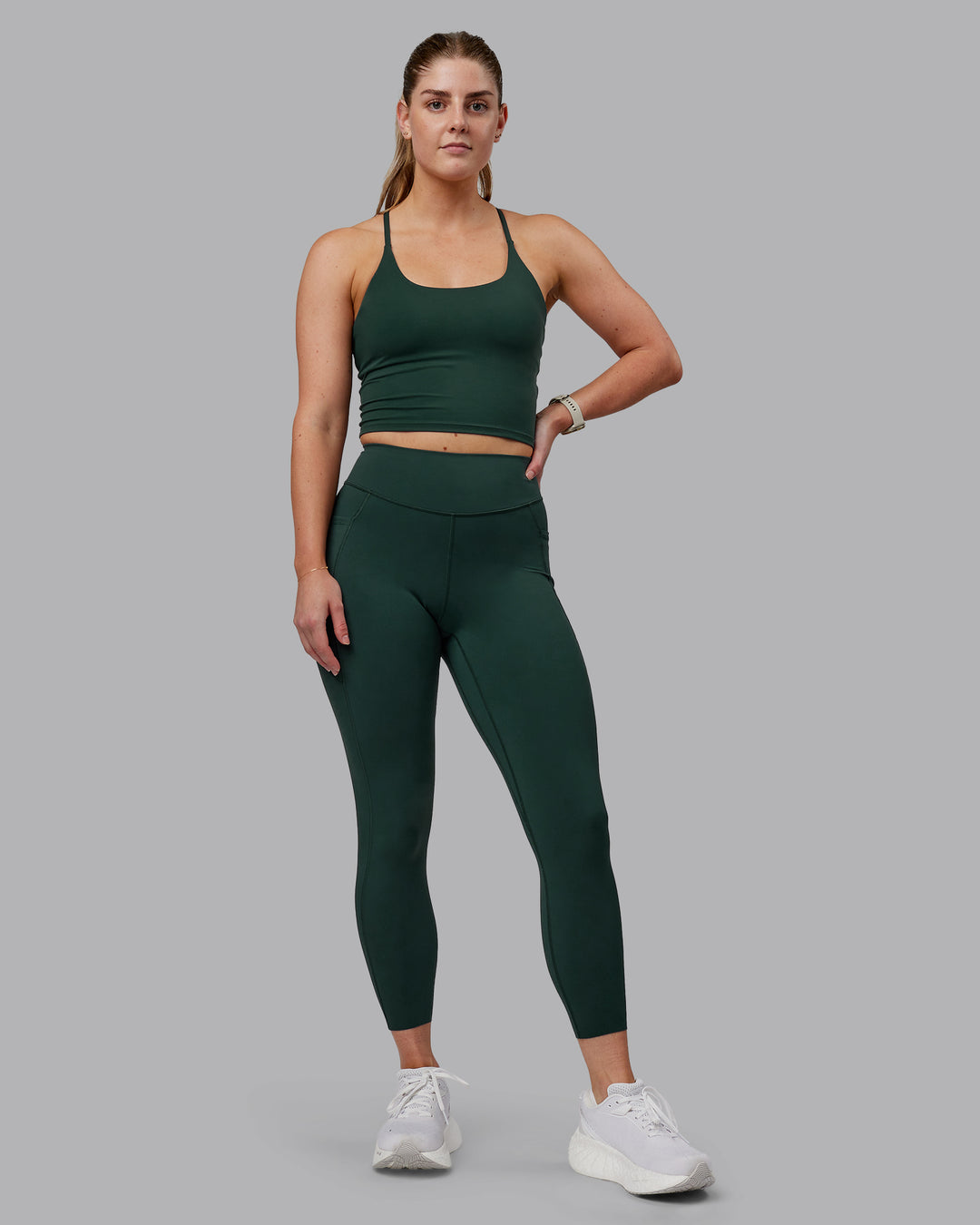 Woman wearing Elite High-Rise 7/8 Legging Pockets - Vital Green