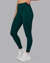 Woman wearing Elite High-Rise Full Length Legging Pockets - Dark Moss | Model:Halle | Size:S