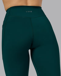 Woman wearing Elite High-Rise Full Length Legging Pockets - Dark Moss | Model:Halle | Size:S