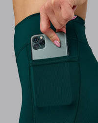 Woman wearing Elite High-Rise Full Length Legging Pockets - Dark Moss | Model:Halle | Size:S