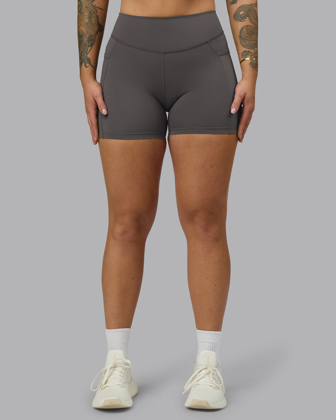 Woman wearing Elite High-Rise 4&quot; Short Pockets - Dark Storm | Model:Robyn | Size:S