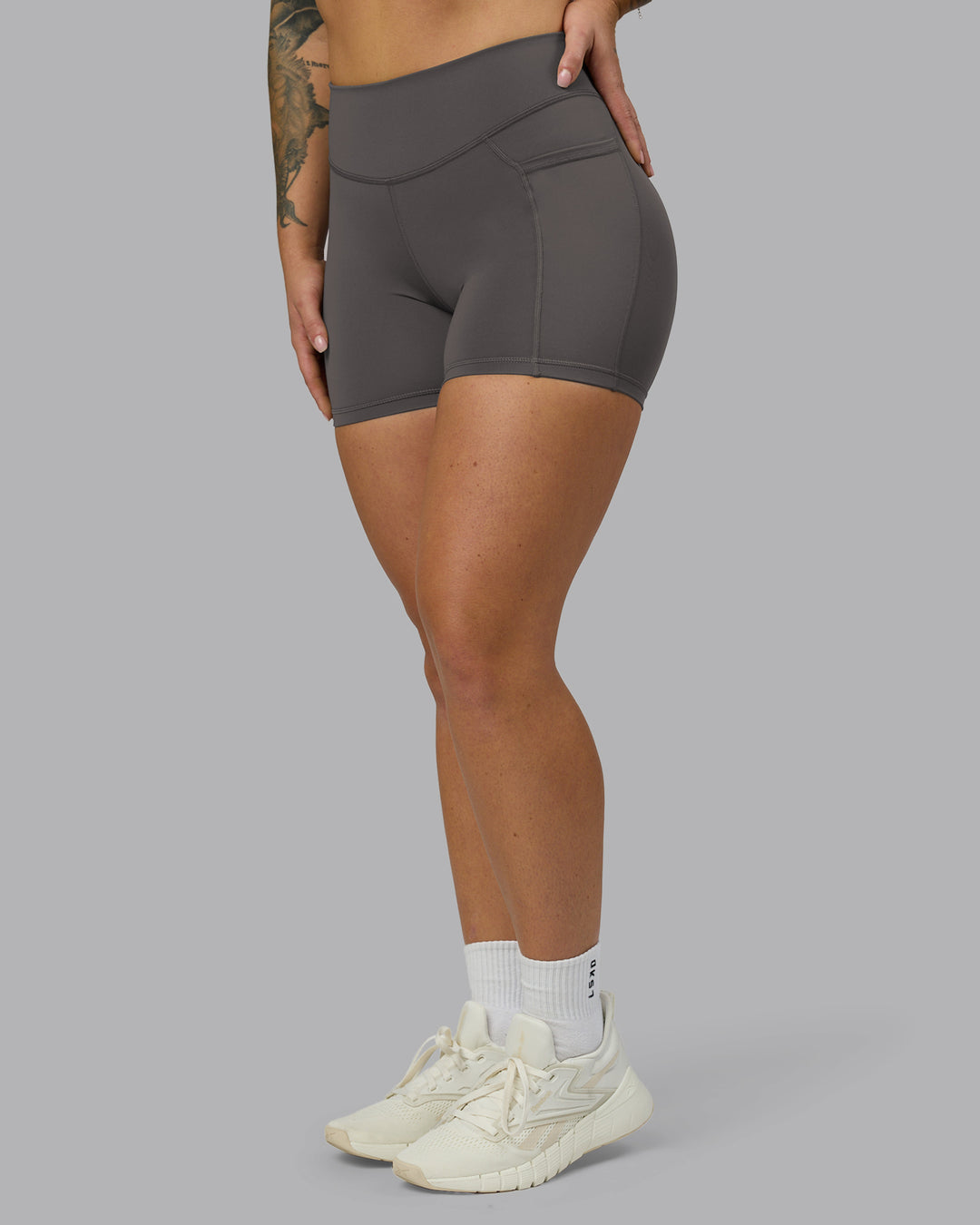 Woman wearing Elite High-Rise 4&quot; Short Pockets - Dark Storm | Model:Robyn | Size:S