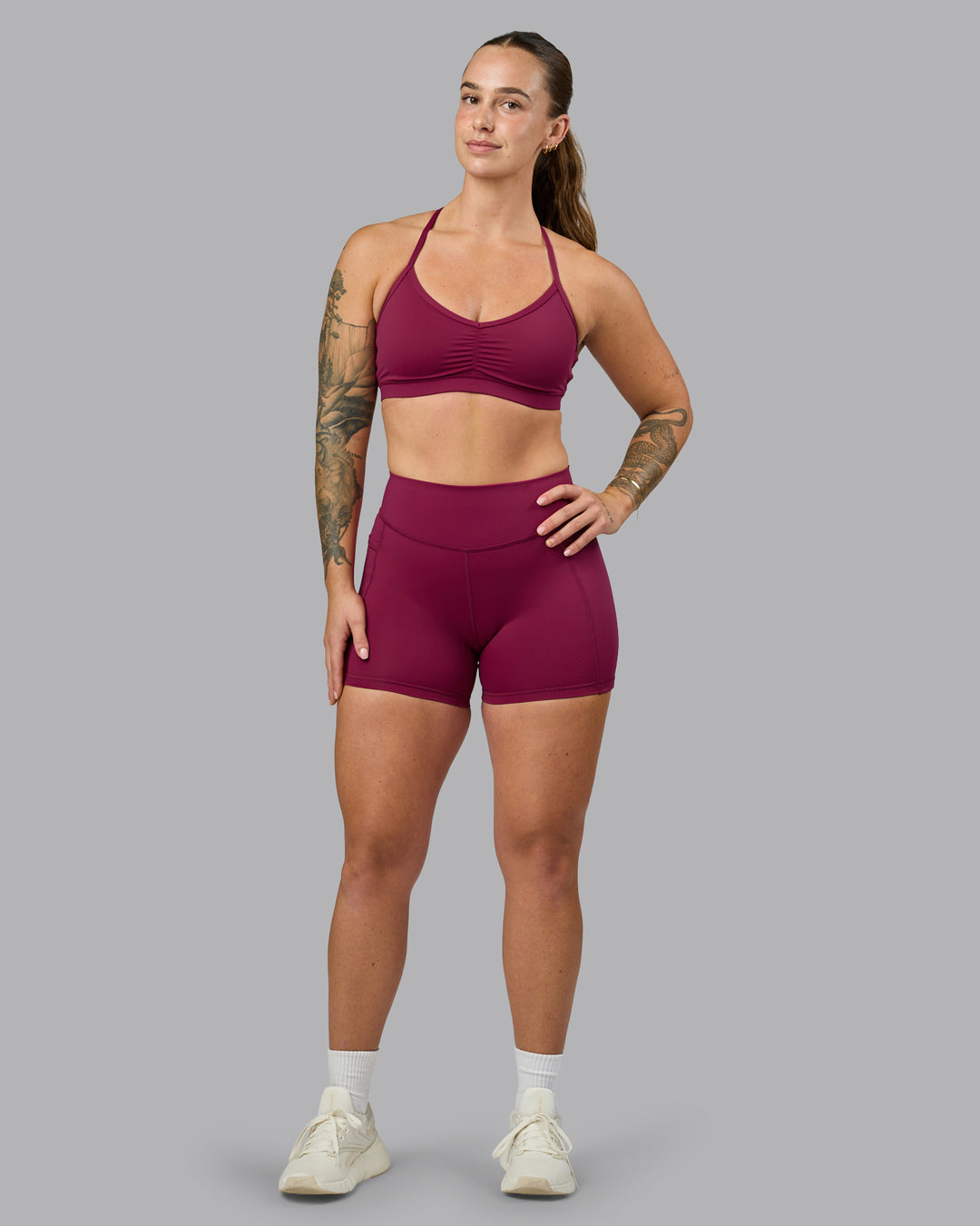 Woman wearing Elite High-Rise 4&quot; Short Pockets - Plum Berry | Model:Robyn | Size:S