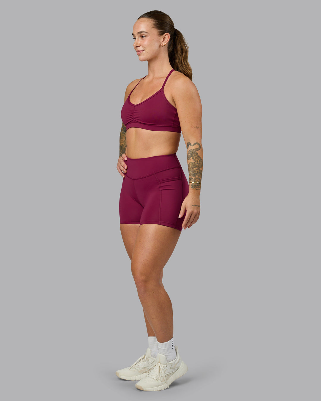 Woman wearing Elite High-Rise 4&quot; Short Pockets - Plum Berry | Model:Robyn | Size:S