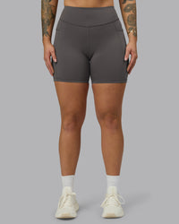 Woman wearing Elite High-Rise 6" Short Pockets - Dark Storm | Model:Robyn | Size:S