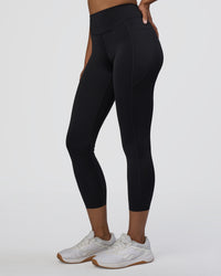 Woman wearing Elite High-Rise 7/8 Legging Pockets - Black | Model:Jordan | Size:S