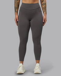 Woman wearing Elite High-Rise 7/8 Legging Pockets - Dark Storm | Model:Robyn | Size:S