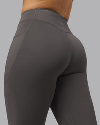 Woman wearing Elite High-Rise 7/8 Legging Pockets - Dark Storm | Model:Robyn | Size:S