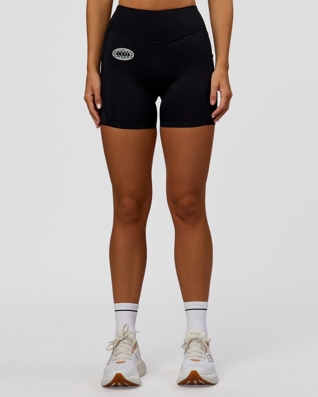 Woman wearing Elite Hype Reflective Run High-Rise 5" Short Pockets - Black-Hype Reflective | Model:Amity | Size:S