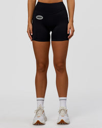 Woman wearing Elite Hype Reflective Run High-Rise 5" Short Pockets - Black-Hype Reflective | Model:Amity | Size:S