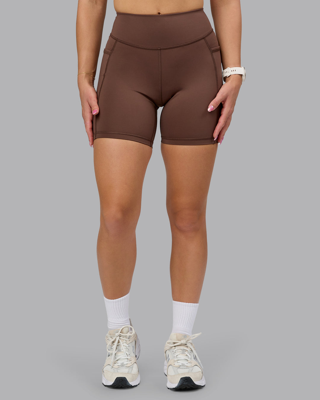 Woman wearing Elite High-Rise 6" Short Pockets - Chocolate Martini | Model: Halle | Size:S