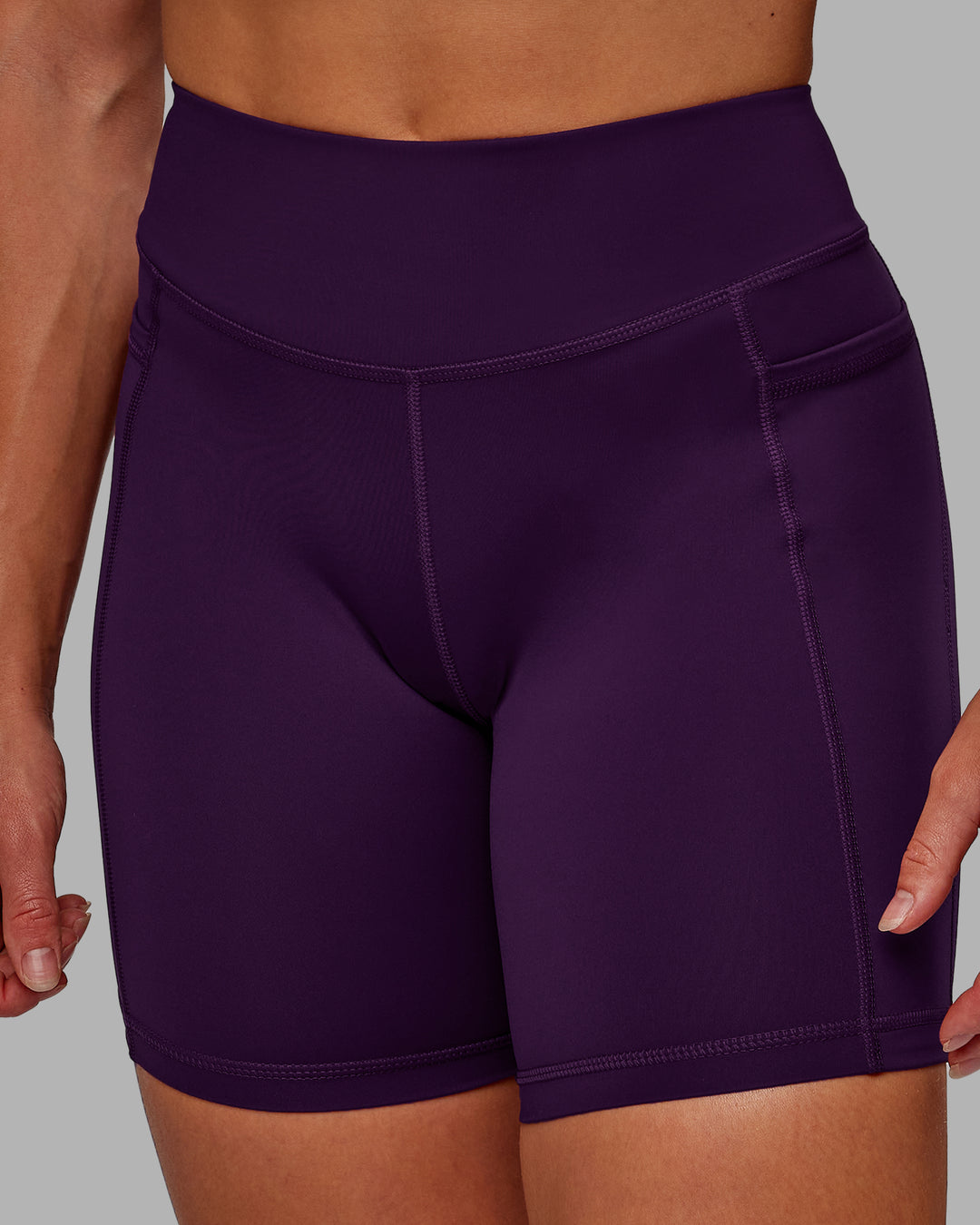 Woman wearing Elite High-Rise 6&quot; Short Pockets in Deep Purple | Size:S