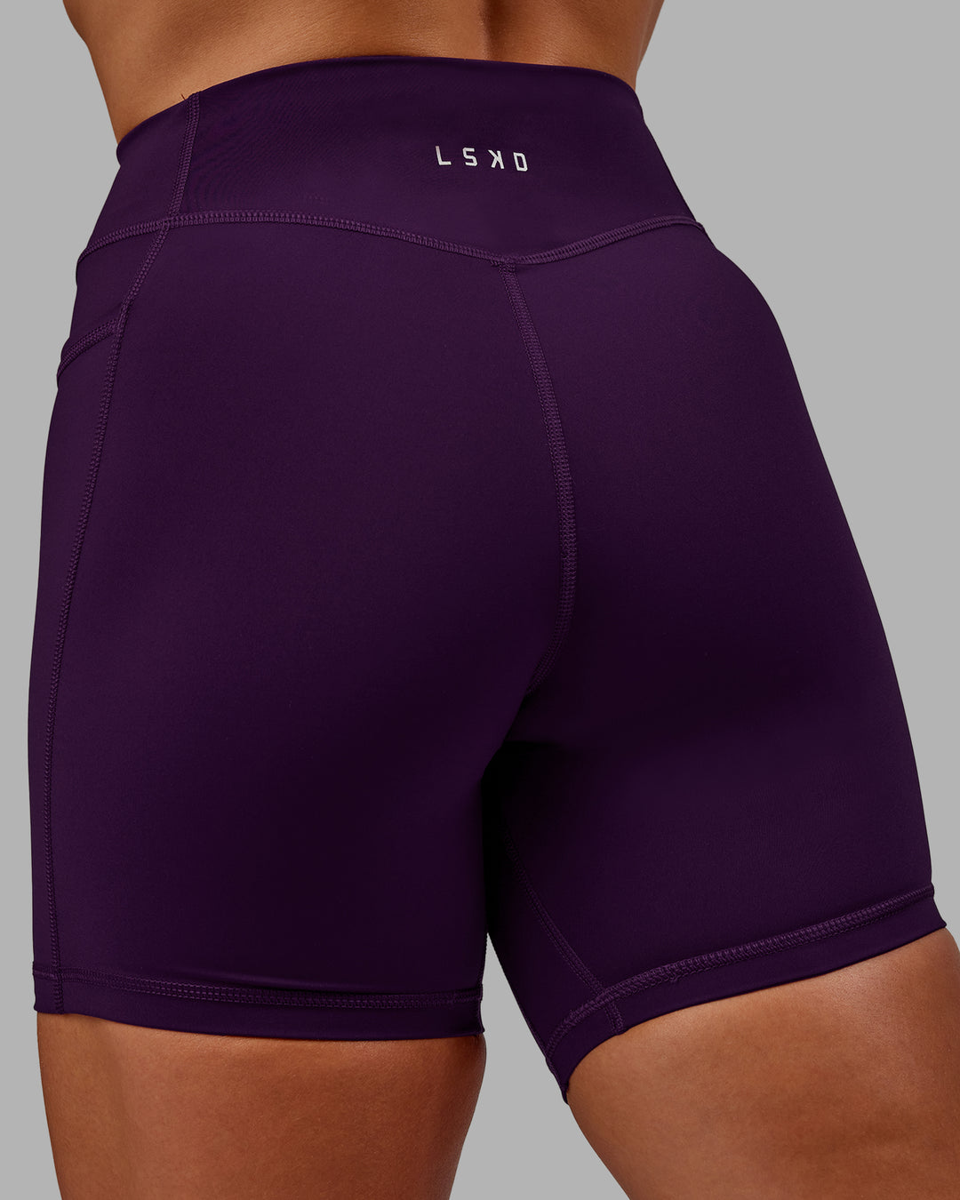 Woman wearing Elite High-Rise 6&quot; Short Pockets in Deep Purple | Size:S