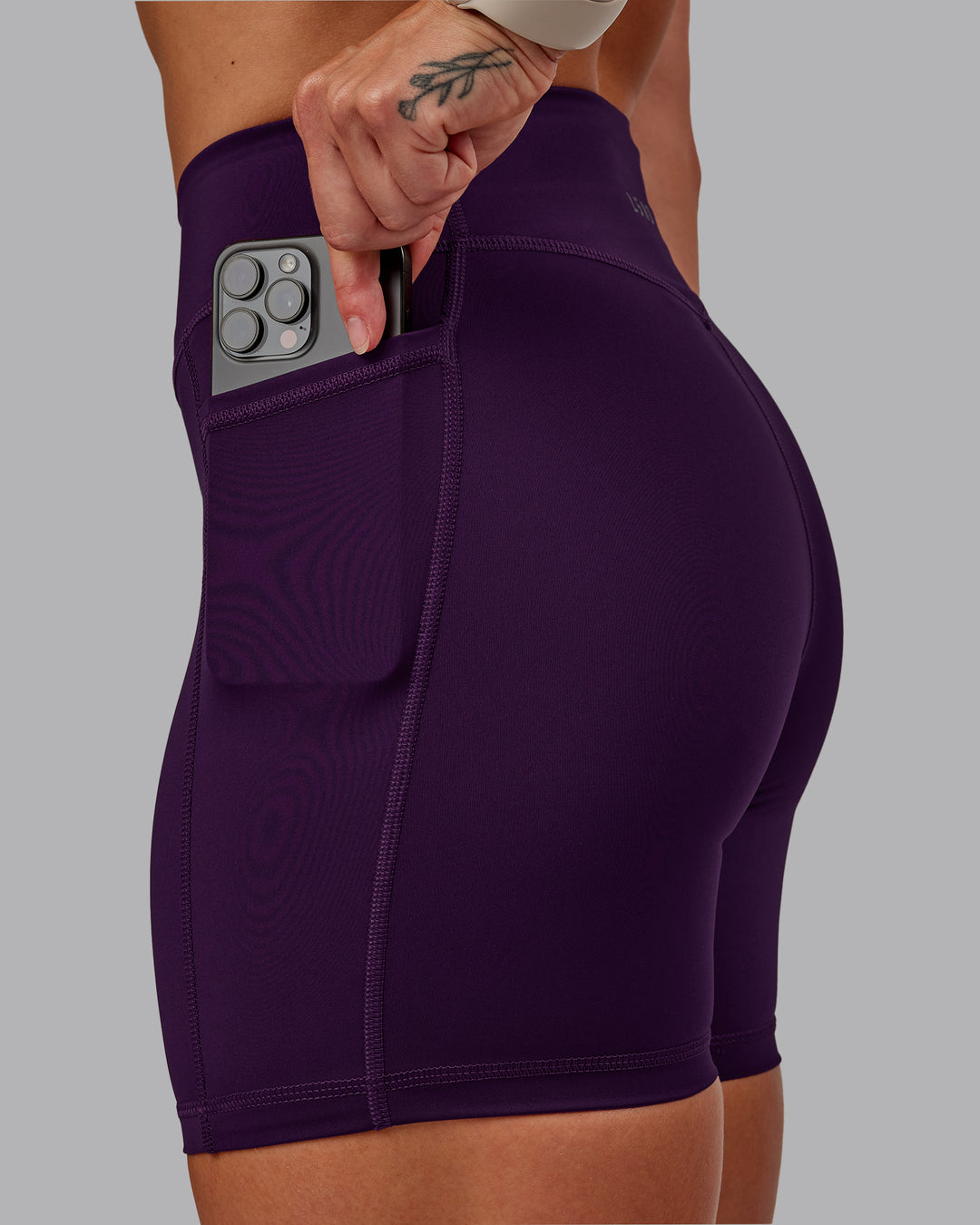 Woman wearing Elite High-Rise 6&quot; Short Pockets in Deep Purple | Size:S