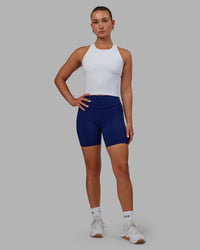 Woman wearing Elite High-Rise 6" Short Pockets - Midnight Blue