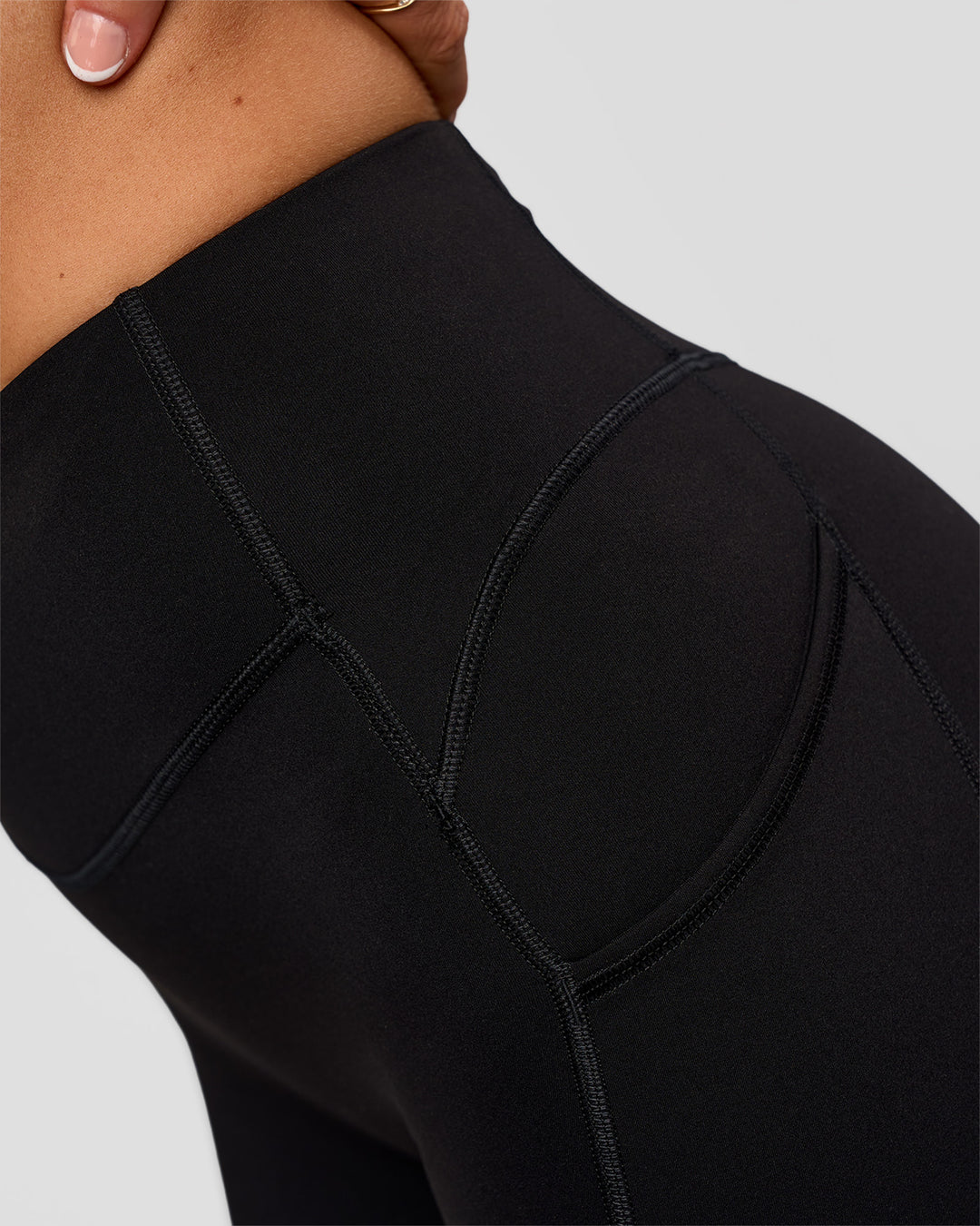 Woman wearing Elite Run High-Rise 5" Short Pockets - Black | Model:Emelia | Size:S