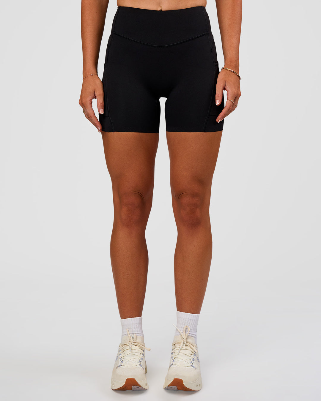 Woman wearing Elite Run High-Rise 5" Short Pockets - Black | Model:Emelia | Size:S