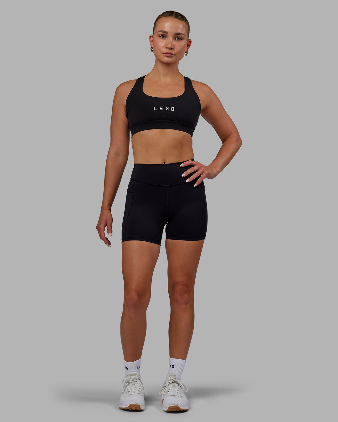 Woman wearing Elite High-Rise 4&quot; Short Pockets - Black