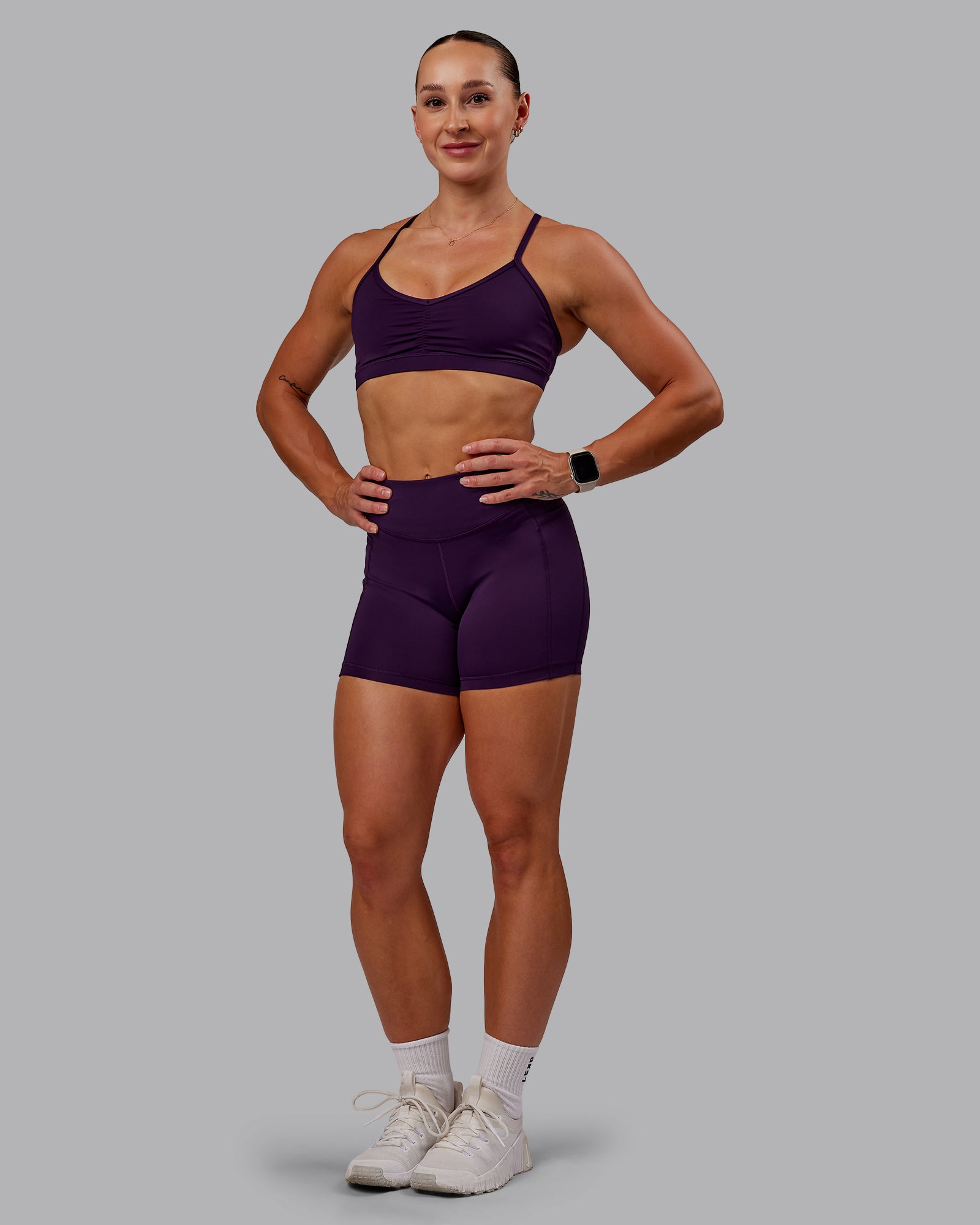 Woman wearing Elite High-Rise 4" Short Pockets - Deep Purple | Size:S