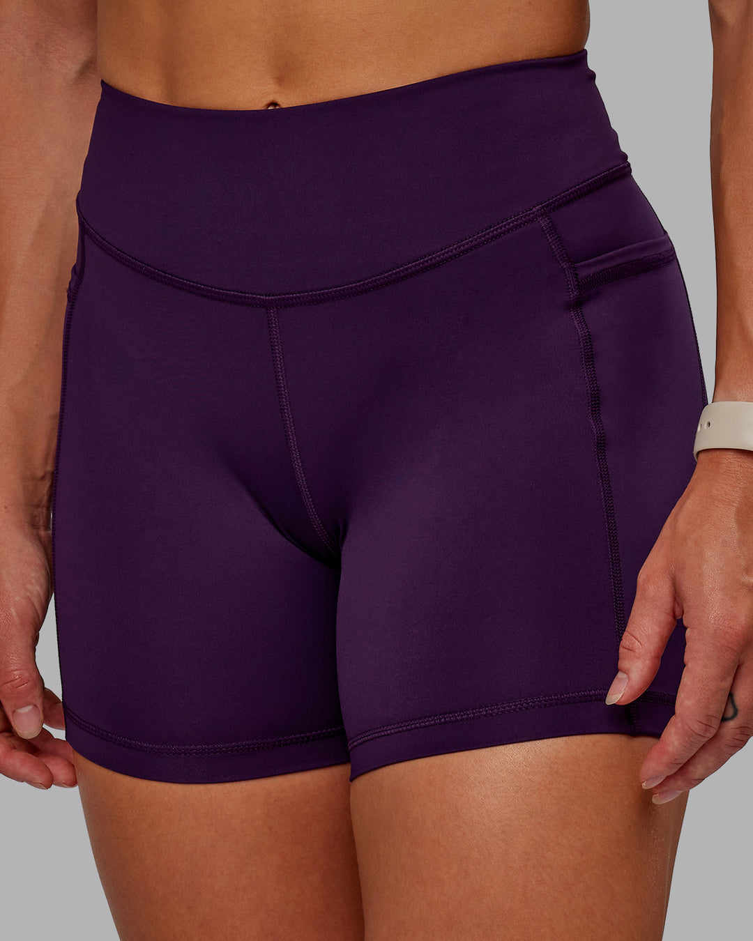 Woman wearing Elite High-Rise 4&quot; Short Pockets - Deep Purple | Size:S