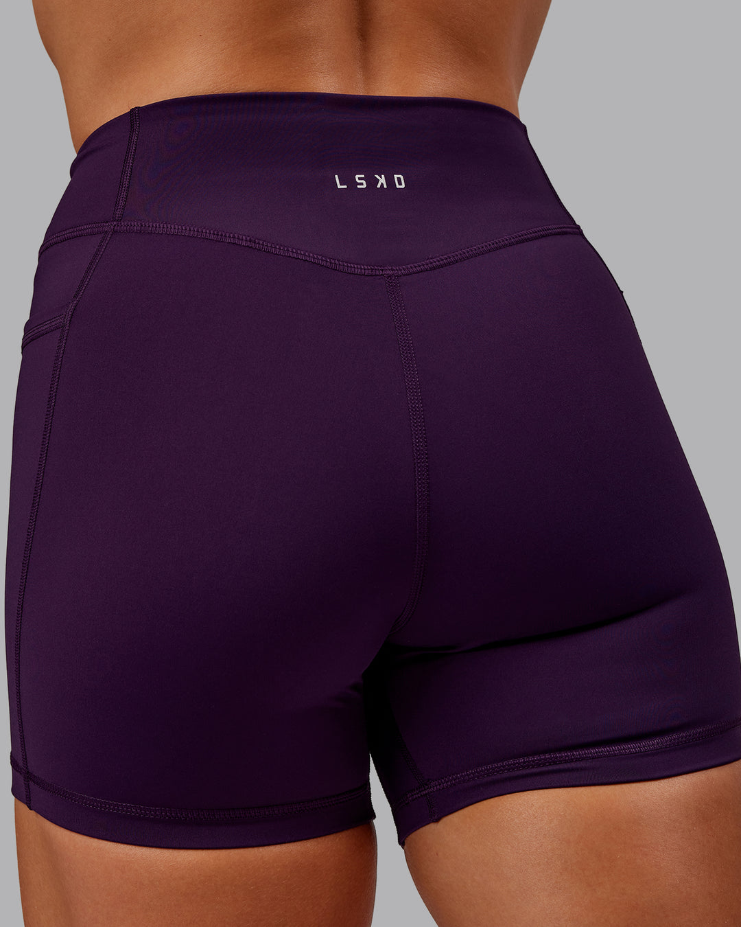 Woman wearing Elite High-Rise 4&quot; Short Pockets - Deep Purple | Size:S