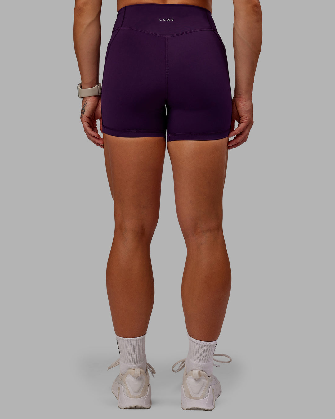Woman wearing Elite High-Rise 4&quot; Short Pockets - Deep Purple | Size:S