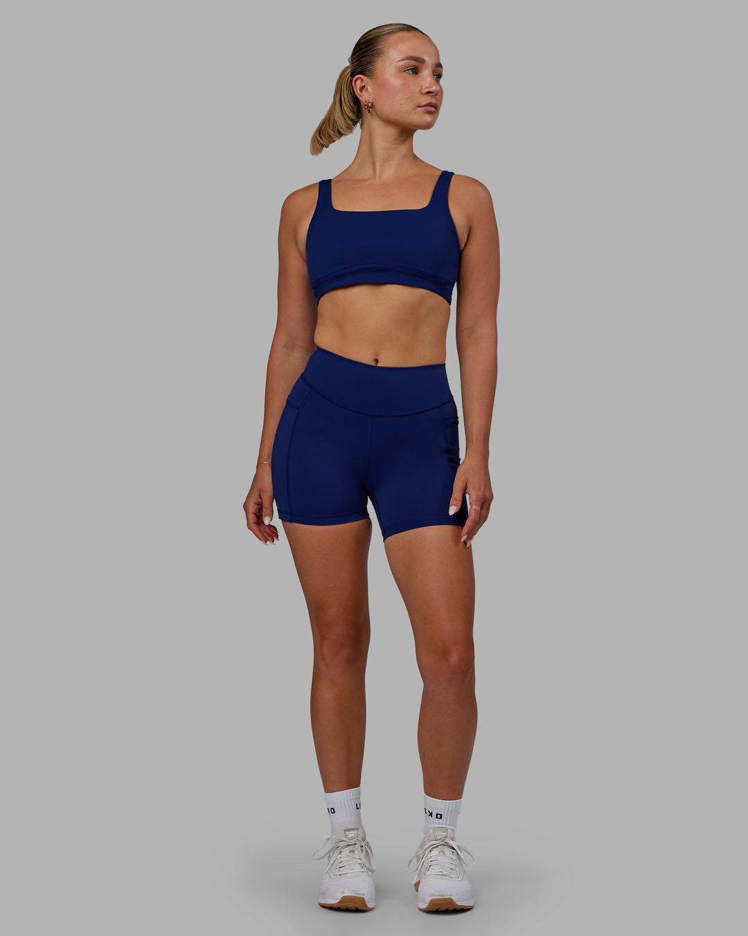 Woman wearing Elite High-Rise 4" Short Pockets - Midnight Blue