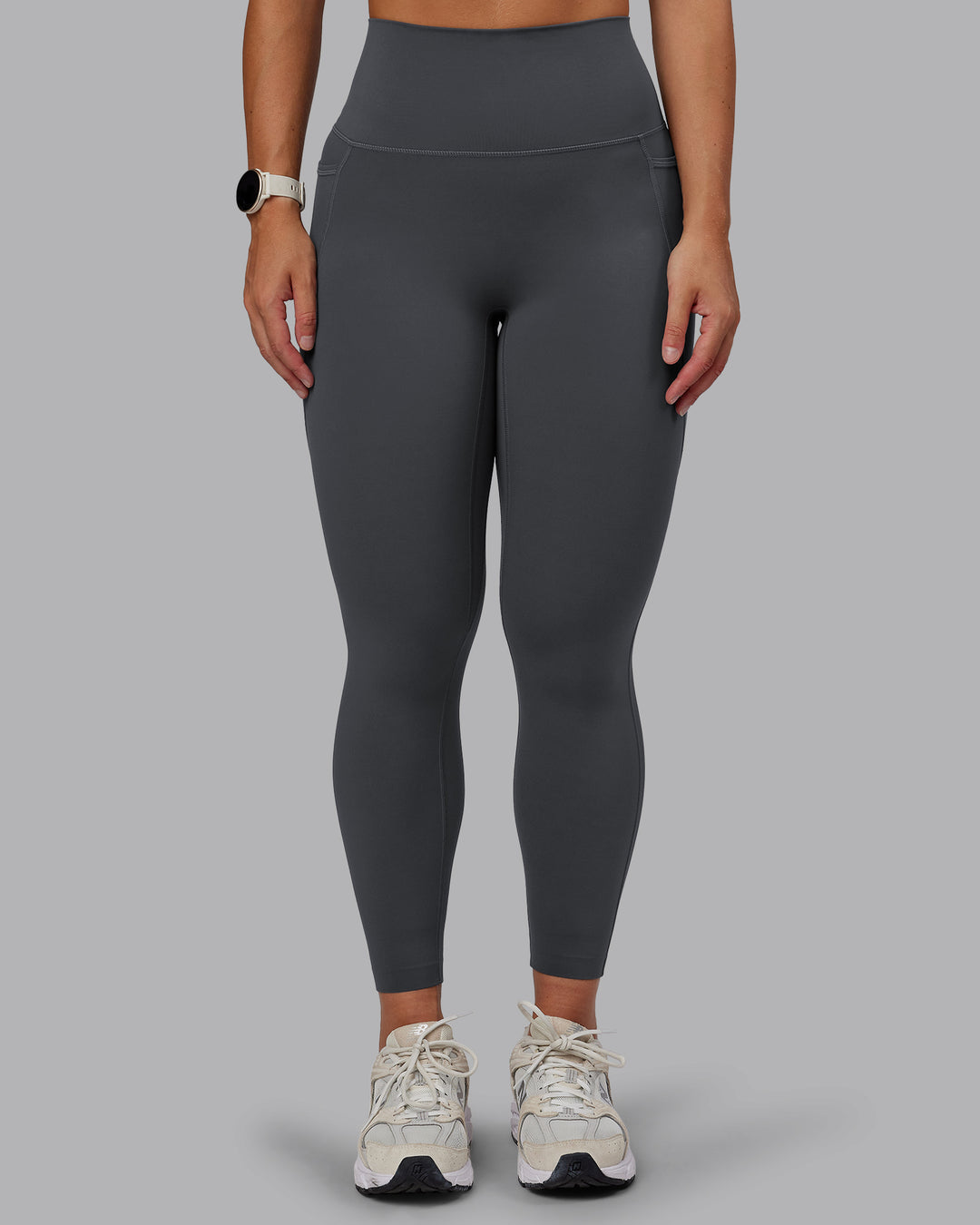 Woman wearing Elixir Ultra High-Rise 7/8 Legging Pockets - Dark Storm | Model:Lyss | Size:S