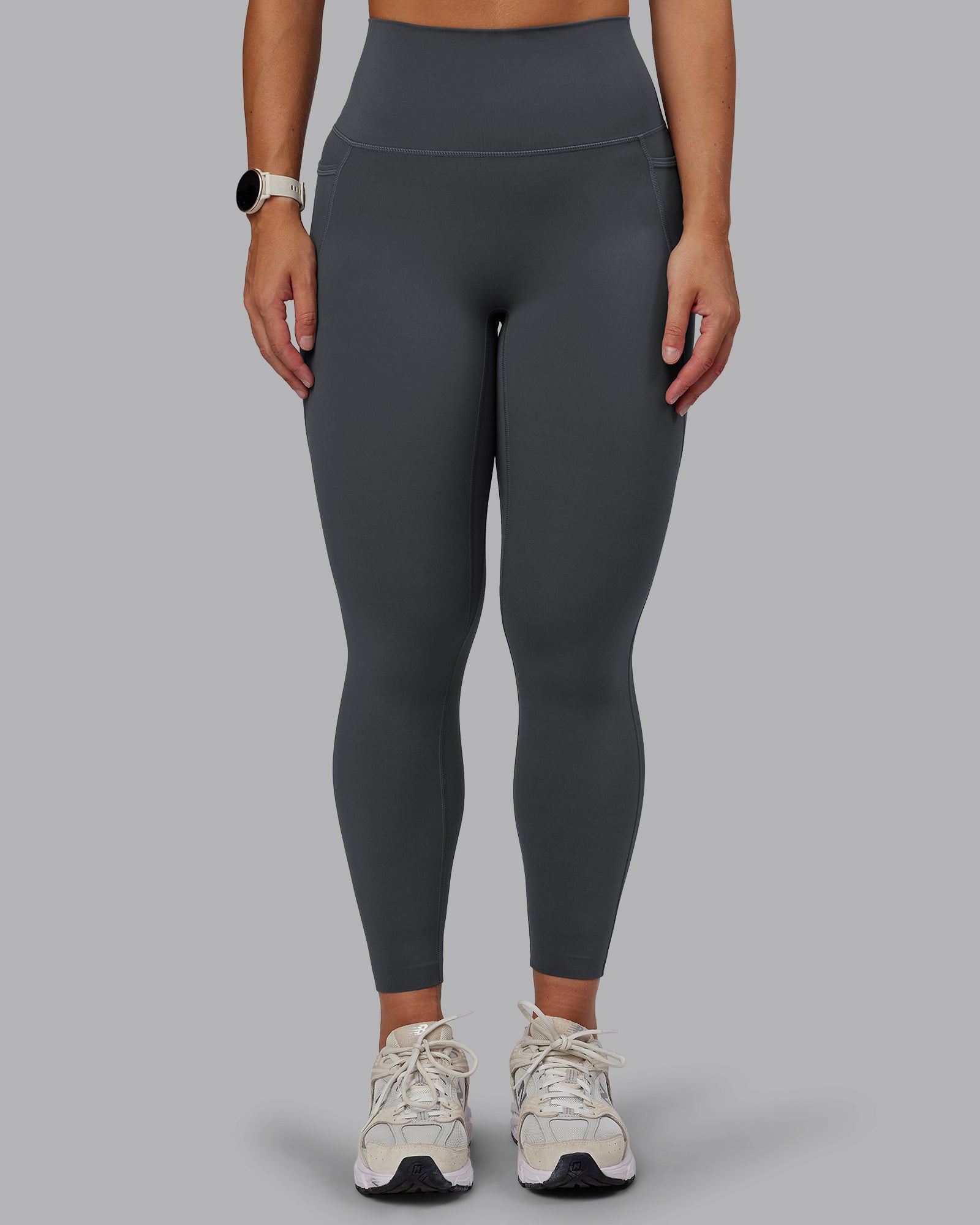 Woman wearing Elixir Ultra High-Rise 7/8 Legging Pockets - Dark Storm | Model:Lyss | Size:S